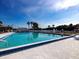 Full view of the community pool under a sunny sky, a relaxing spot with a view of the lake at 1312 Apache Cir, Tavares, FL 32778