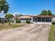 Inviting single-story home with a spacious driveway and lovely curb appeal at 1312 Apache Cir, Tavares, FL 32778