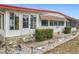 Charming home entrance with decorative planters and an enclosed porch at 1312 Apache Cir, Tavares, FL 32778