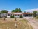 Charming single-story home featuring mature landscaping and a cozy front porch at 1312 Apache Cir, Tavares, FL 32778