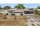 Inviting single-story home featuring a long driveway and a cozy screened-in porch at 1312 Apache Cir, Tavares, FL 32778