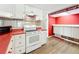 Kitchen with white cabinets and a red countertop that adds a striking contrast to the space at 1312 Apache Cir, Tavares, FL 32778