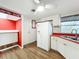 Charming kitchen with modern appliances, laminate floors, and bright lighting at 1312 Apache Cir, Tavares, FL 32778
