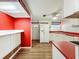 Bright kitchen with red accents, white cabinets, and new appliances at 1312 Apache Cir, Tavares, FL 32778