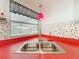 Close up view of kitchen sink with red countertop and black and white checkered valance at 1312 Apache Cir, Tavares, FL 32778