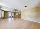 Bright and airy living room with wood-look floors and ample space for entertaining at 1312 Apache Cir, Tavares, FL 32778