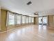 Bright living room with ceiling fan, hardwood flooring, and an inviting atmosphere at 1312 Apache Cir, Tavares, FL 32778