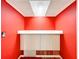 View of red room featuring storage cabinets under a shelf and interesting lighting fixture at 1312 Apache Cir, Tavares, FL 32778