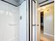 This bathroom features a standing shower with storage shelves and an open door at 1312 Apache Cir, Tavares, FL 32778