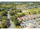 A scenic aerial view of a residential area near a golf course, offering lush greenery at 1502 Aalto Pl, Lady Lake, FL 32159