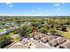 An aerial view of a neighborhood showing well-maintained homes and lush landscaping at 1502 Aalto Pl, The Villages, FL 32159