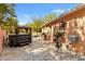 Spacious backyard brick patio featuring a gazebo, hot tub, and decorative fountains and planters at 1502 Aalto Pl, The Villages, FL 32159