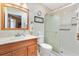 Well-lit bathroom with a shower featuring glass doors, and a vanity with a light wood cabinet at 1502 Aalto Pl, Lady Lake, FL 32159