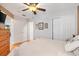 Bedroom with white walls, ceiling fan, light hardwood floors, and double door closet at 1502 Aalto Pl, The Villages, FL 32159