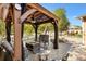 Outdoor gazebo featuring a ceiling fan, black curtains, and elegant furniture on a brick patio at 1502 Aalto Pl, Lady Lake, FL 32159