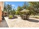 Outdoor patio area with brick pavers, dining table and chairs, landscaping, and pergola at 1502 Aalto Pl, Lady Lake, FL 32159