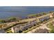 Breathtaking aerial view of pristine townhomes, with stunning lake views, and scenic surroundings at 164 Nautica Mile Dr, Clermont, FL 34711