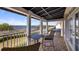 Inviting balcony with a table and chairs offers stunning views of the lake and surroundings at 164 Nautica Mile Dr, Clermont, FL 34711