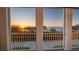 A large sunset viewed from a balcony overlooking lake and trees at 164 Nautica Mile Dr, Clermont, FL 34711