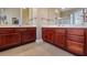 Bathroom features double sink vanities with wood cabinets and tile flooring at 164 Nautica Mile Dr, Clermont, FL 34711