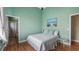 Comfortable bedroom boasts stylish wood flooring, calming paint, and a tranquil atmosphere for relaxation at 164 Nautica Mile Dr, Clermont, FL 34711