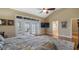 View of main bedroom with vaulted ceiling, wood floors, and French doors to outside balcony at 164 Nautica Mile Dr, Clermont, FL 34711