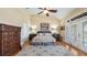 Beautiful main bedroom with vaulted ceiling, wood floors, rug and French doors to outside balcony at 164 Nautica Mile Dr, Clermont, FL 34711