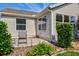 Outdoor back patio showcasing simple furniture and a well-maintained exterior at 16721 Se 77Th Northridge Ct, The Villages, FL 32162