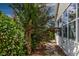Landscaped backyard featuring a stone walkway next to the home's exterior at 16721 Se 77Th Northridge Ct, The Villages, FL 32162
