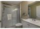 Cozy bathroom featuring a glass-enclosed shower, toilet, and vanity with a sink and mirror at 16721 Se 77Th Northridge Ct, The Villages, FL 32162