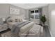 Virtually staged bedroom with a queen bed, matching bedside tables, and a window view at 16721 Se 77Th Northridge Ct, The Villages, FL 32162