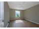 Empty bedroom with updated flooring and a window that provides natural light and backyard views at 16721 Se 77Th Northridge Ct, The Villages, FL 32162