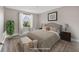 Virtually staged bedroom showcasing a comfy queen-sized bed, plush carpeting, and natural light at 16721 Se 77Th Northridge Ct, The Villages, FL 32162