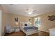 Cozy bedroom with a ceiling fan, a window, and a white bed with blue patterned bedding at 16721 Se 77Th Northridge Ct, The Villages, FL 32162