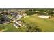 Aerial view showcasing community amenities like a pool, sports field, and clubhouse in a beautiful setting at 16721 Se 77Th Northridge Ct, The Villages, FL 32162