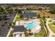 Aerial view showcasing a large, uniquely shaped community pool and surrounding recreation areas at 16721 Se 77Th Northridge Ct, The Villages, FL 32162