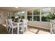 Sun-filled dining room with a modern table and chairs set, complimented by large windows at 16721 Se 77Th Northridge Ct, The Villages, FL 32162