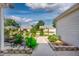 Landscaped walkway with beautiful foliage leads to a charming home in a serene community at 16721 Se 77Th Northridge Ct, The Villages, FL 32162