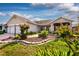 Beautiful home featuring a two-car garage, manicured lawn, and lovely landscaping for great curb appeal at 16721 Se 77Th Northridge Ct, The Villages, FL 32162