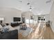Bright living room with neutral colors, high ceilings, ceiling fan, hardwood floors, and lots of natural light at 16721 Se 77Th Northridge Ct, The Villages, FL 32162