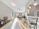 Open-concept living room with hardwood floors, modern lighting, and seamless flow into dining and kitchen areas at 16721 Se 77Th Northridge Ct, The Villages, FL 32162