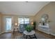 Cozy living room with vaulted ceilings, hardwood floors, and ample natural light at 16721 Se 77Th Northridge Ct, The Villages, FL 32162