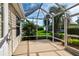 Spacious screened patio with a view of the landscaped backyard at 16721 Se 77Th Northridge Ct, The Villages, FL 32162