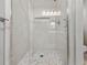 Modern tiled shower with glass enclosure and decorative niche at 16721 Se 77Th Northridge Ct, The Villages, FL 32162