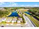 Aerial view of the property showcasing a backyard pool and pond at 17024 Goldcrest Loop, Clermont, FL 34714