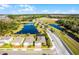 Aerial view of the property showcasing a backyard pool and pond at 17024 Goldcrest Loop, Clermont, FL 34714