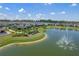 Aerial view showing community lake and playground in a community of homes at 17024 Goldcrest Loop, Clermont, FL 34714