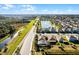 Aerial view of a community with pond, pool and beautiful homes at 17024 Goldcrest Loop, Clermont, FL 34714