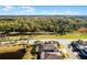 Aerial view of the property showcasing a backyard pool and surrounding pond at 17024 Goldcrest Loop, Clermont, FL 34714