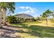 Well maintained backyard showing a screened-in pool and abundant grass at 17024 Goldcrest Loop, Clermont, FL 34714